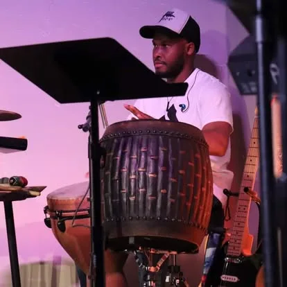 A percussionist playing during worship at The Refuge.