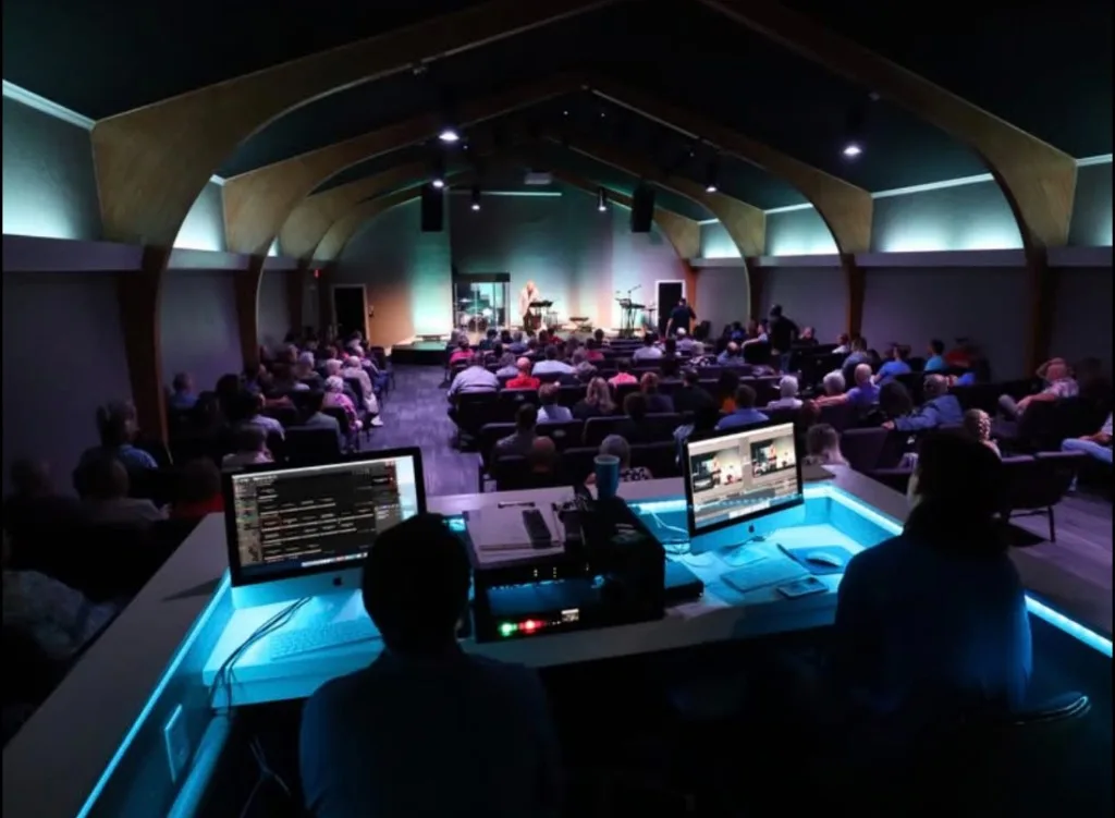The media and sound team serving from the tech booth during a Refuge service.